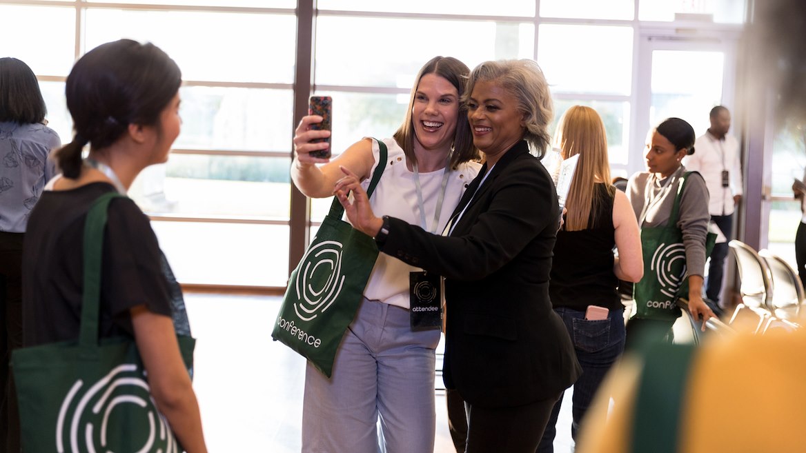 Conference Attendee Taking a Selfie with a Conference Speaker